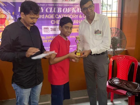 Arnav receiving a trophy at the Rotary Club of Kalyan under-12 tournament