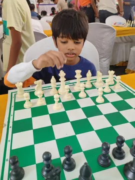 Dhyan concentrating over a chessboard during a tournament game
