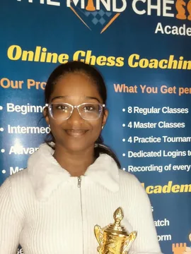 Khyathi smiling and holding a trophy
